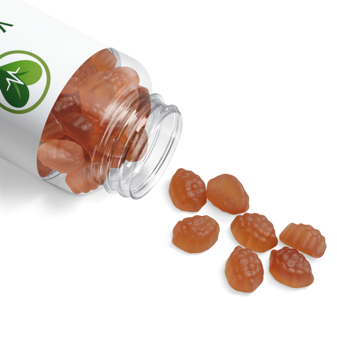 Brown gummy supplements spilling from a white bottle onto a surface.